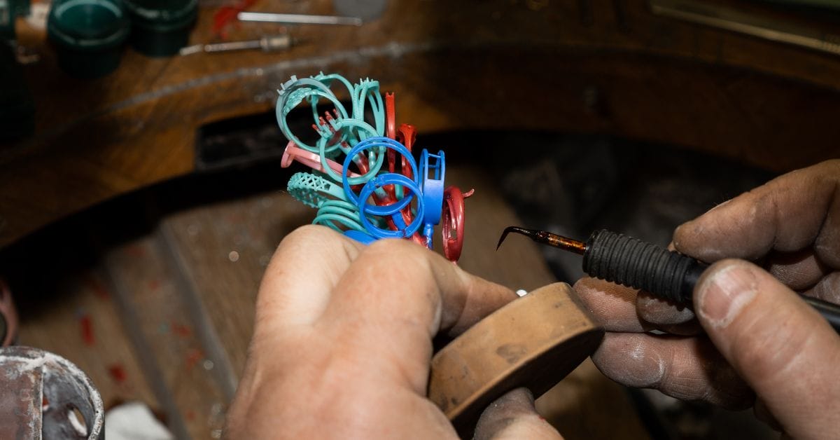 Hands holding colorful plastic rings in jewelry making